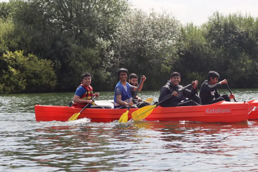 Young people canoeing together on a trip